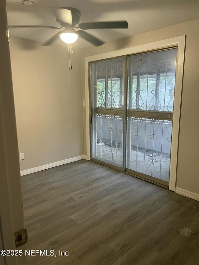 unfurnished room with ceiling fan and dark hardwood / wood-style flooring