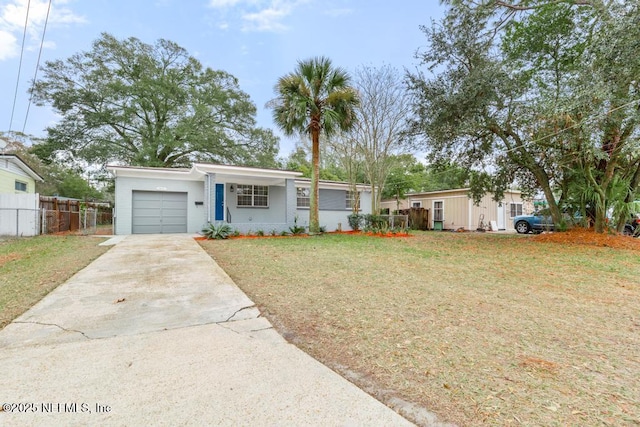 single story home featuring a garage and a front yard