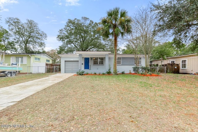 view of front of property with a garage and a front lawn