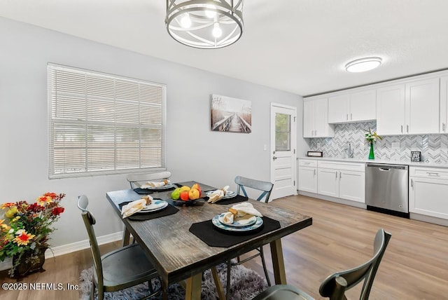 dining space with sink and light hardwood / wood-style floors