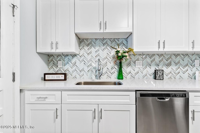 kitchen featuring sink, stainless steel dishwasher, and white cabinetry