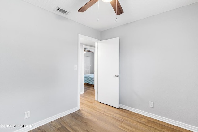 empty room featuring light wood-type flooring and ceiling fan