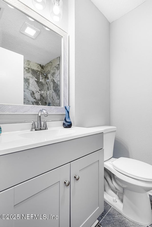 bathroom with tile patterned floors, vanity, and toilet