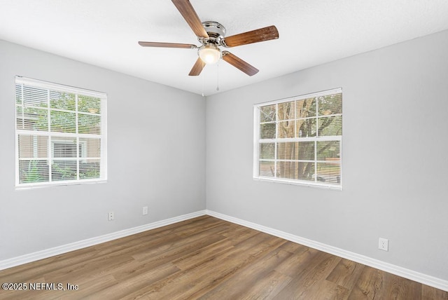 unfurnished room with ceiling fan, wood-type flooring, and a healthy amount of sunlight