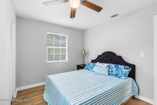 bedroom with ceiling fan and hardwood / wood-style floors