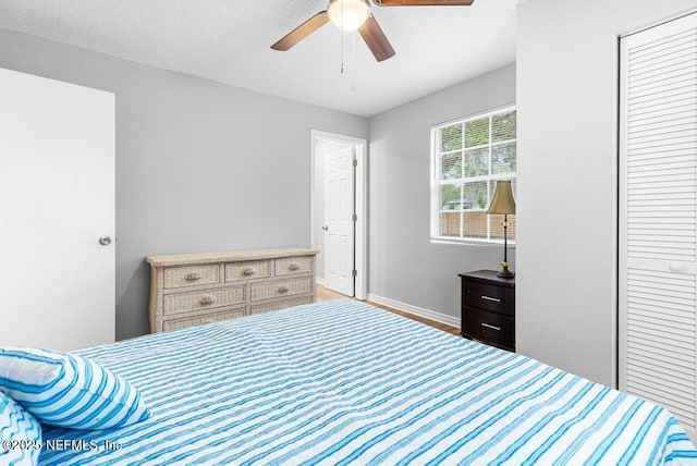 bedroom with ceiling fan and a closet