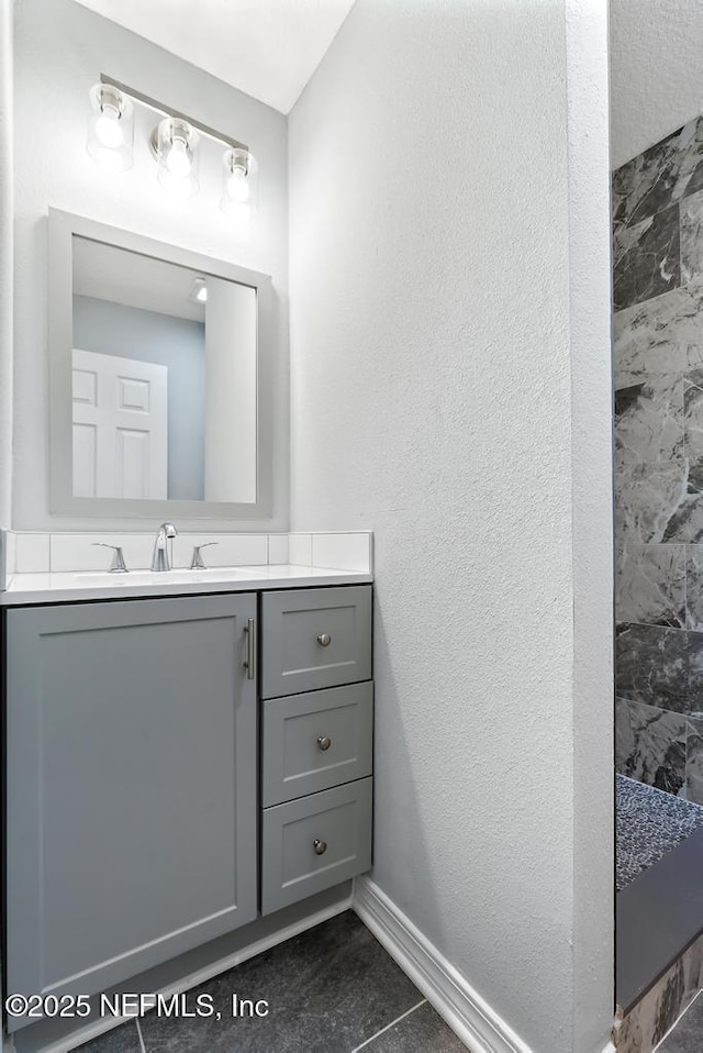 bathroom featuring walk in shower, tile patterned floors, and vanity