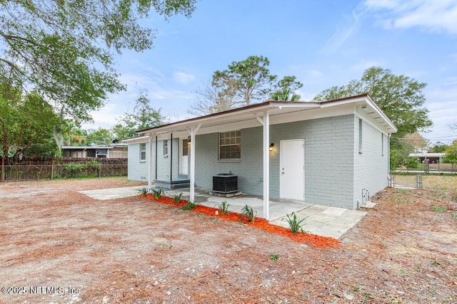 rear view of property featuring a patio area and central air condition unit