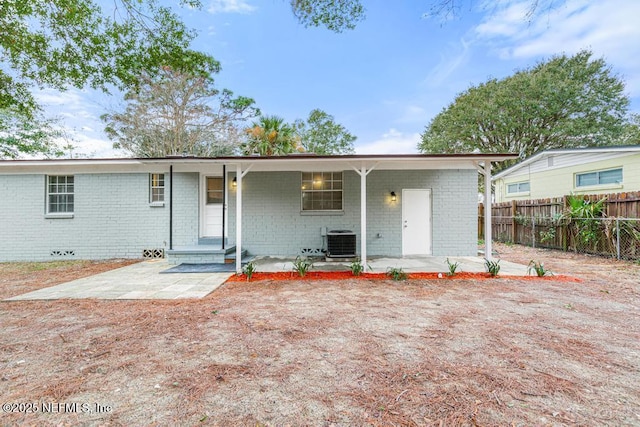 back of property with central air condition unit and a patio area