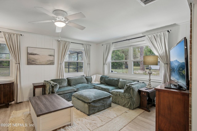 living room featuring ceiling fan and light hardwood / wood-style floors