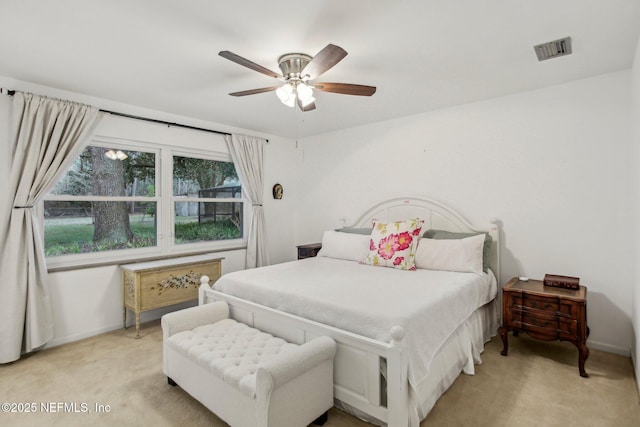 bedroom featuring light carpet and ceiling fan