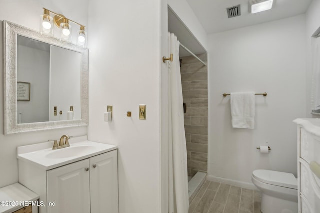 bathroom featuring vanity, toilet, and a shower with shower curtain