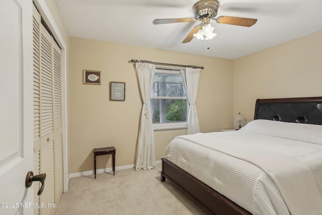 carpeted bedroom with a closet and ceiling fan