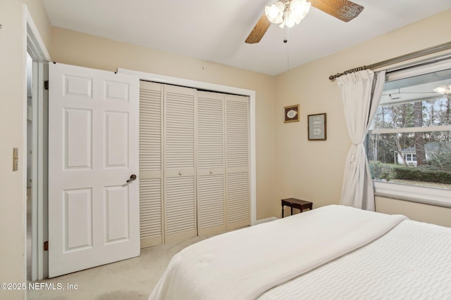 bedroom featuring light carpet, a closet, and ceiling fan