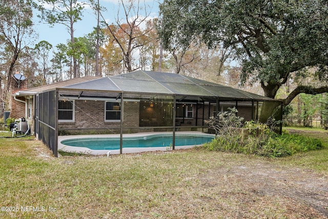 view of pool featuring a yard and a lanai