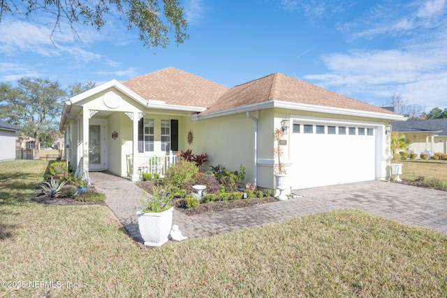 ranch-style house with a garage, covered porch, and a front lawn