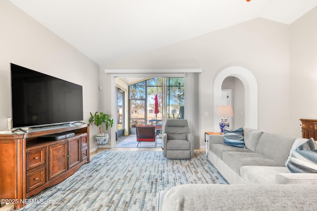 living room featuring lofted ceiling