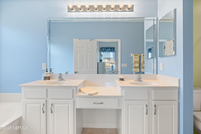 bathroom with vanity, a bathing tub, tile patterned floors, and toilet