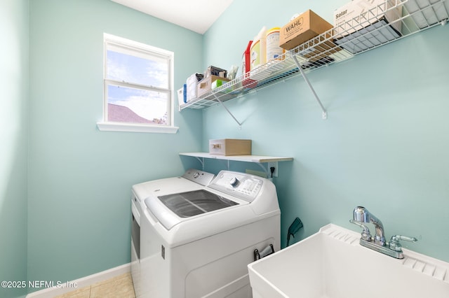 laundry area featuring washing machine and clothes dryer and sink