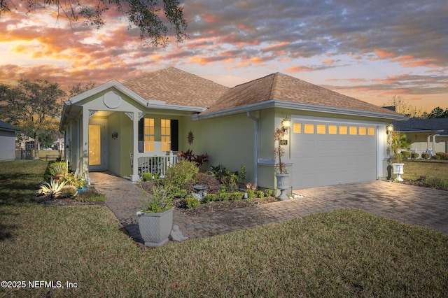 697 Copperhead Cir, Saint Augustine, FL 32092 - single story home featuring stucco siding, roof with shingles, decorative driveway, a front lawn, and a garage