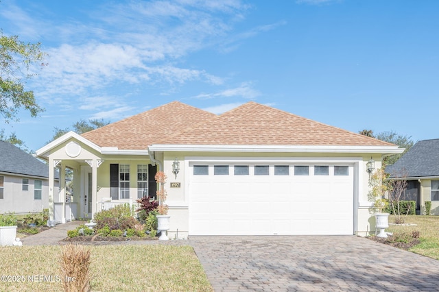 697 Copperhead Cir, Saint Augustine, FL 32092 - ranch-style house featuring driveway, stucco siding, a garage, and roof with shingles