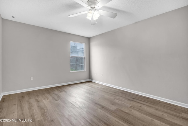 unfurnished room with ceiling fan, a textured ceiling, and light hardwood / wood-style floors