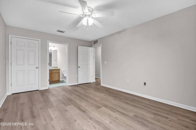 unfurnished bedroom featuring ceiling fan, connected bathroom, and light hardwood / wood-style floors