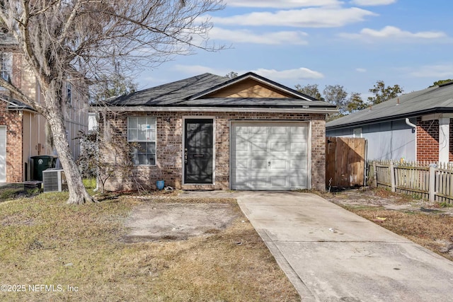 view of front of home featuring central AC and a garage