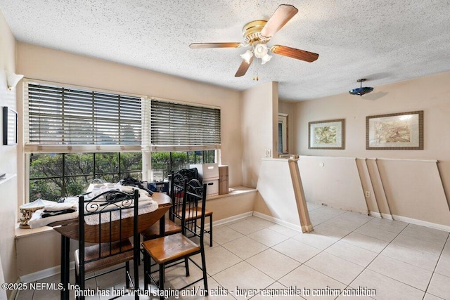 dining area with ceiling fan, a textured ceiling, and light tile patterned floors