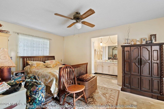 bedroom featuring ceiling fan, ensuite bathroom, and a textured ceiling