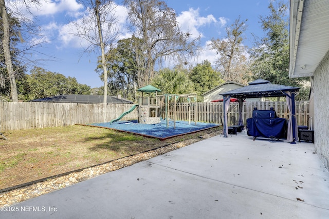 view of jungle gym featuring a yard, a gazebo, and a patio