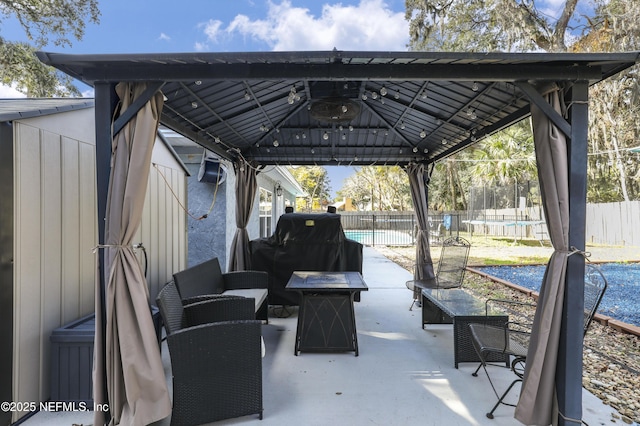 view of patio / terrace with a gazebo, a grill, a fenced in pool, and a trampoline