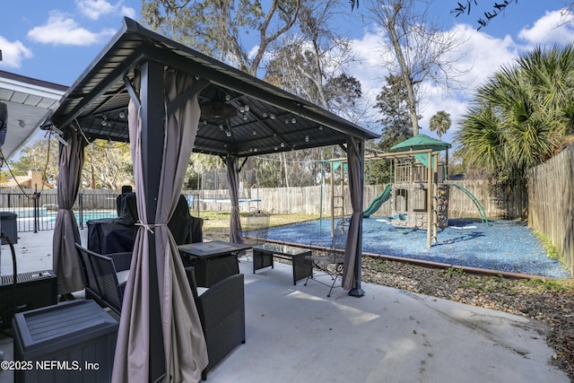 view of patio / terrace featuring a playground and a gazebo