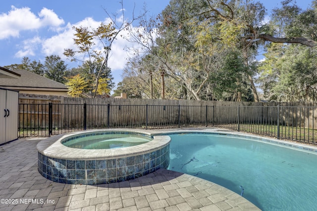 view of swimming pool featuring an in ground hot tub