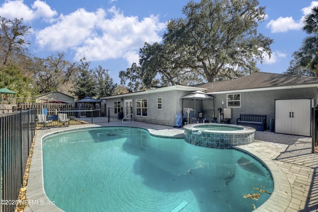 view of swimming pool featuring an in ground hot tub and a patio area