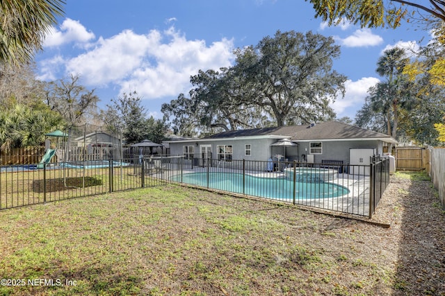 view of swimming pool featuring a lawn, a playground, and a patio area