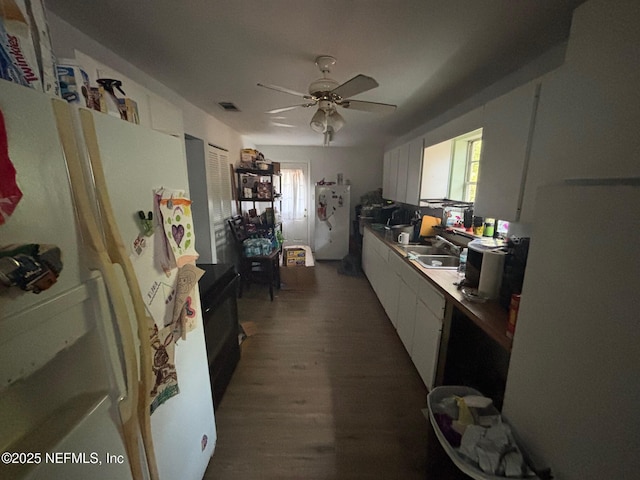 kitchen featuring white cabinetry, a wealth of natural light, white refrigerator, and fridge