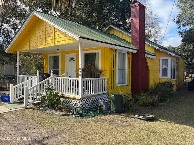 bungalow-style home with a front yard and a porch