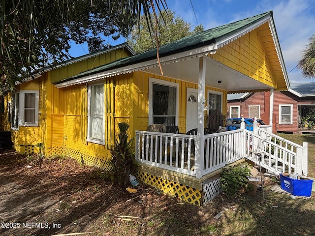 rear view of property featuring a porch