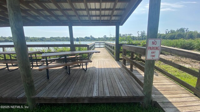 view of dock with a gazebo and a water view