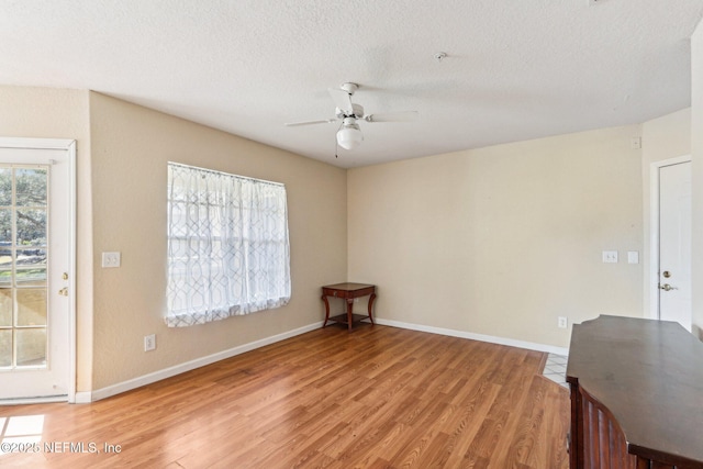 spare room with ceiling fan, hardwood / wood-style floors, and a textured ceiling