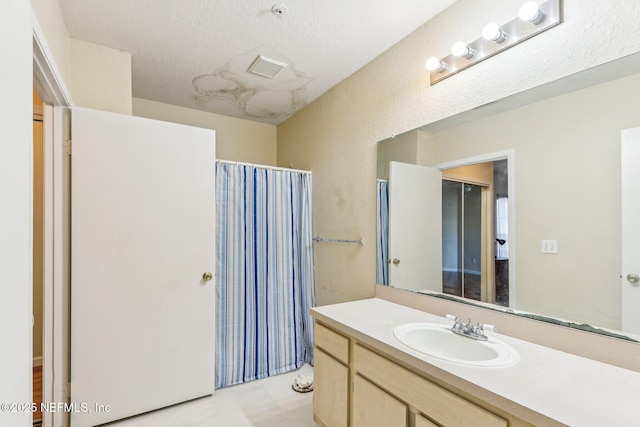 bathroom featuring vanity and curtained shower