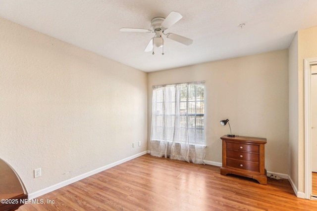 unfurnished room featuring ceiling fan and light wood-type flooring