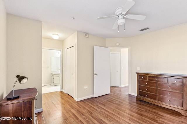 bedroom with hardwood / wood-style floors, ensuite bath, a closet, and ceiling fan