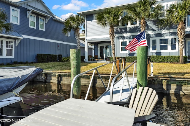 view of dock featuring a yard and a water view