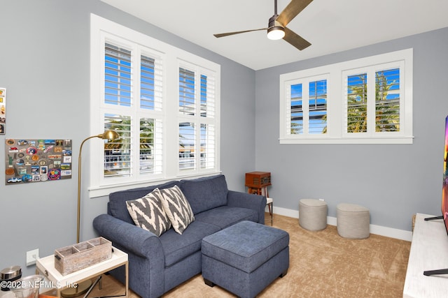 living room with light carpet and ceiling fan