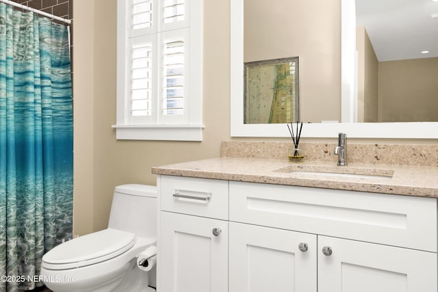 bathroom featuring vanity and toilet