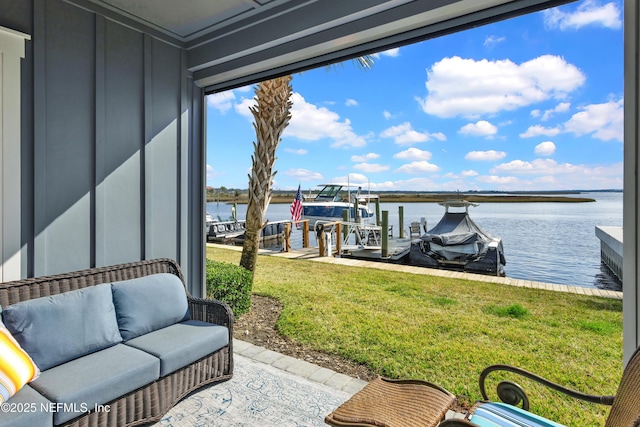 view of dock featuring a water view and a yard