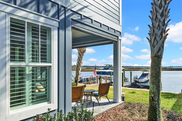 view of patio / terrace featuring a water view and a boat dock