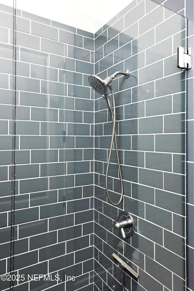 bathroom with tiled shower